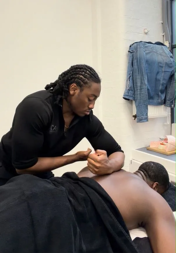 A sports masseur giving a sports massage at a client's home in Forest Gate